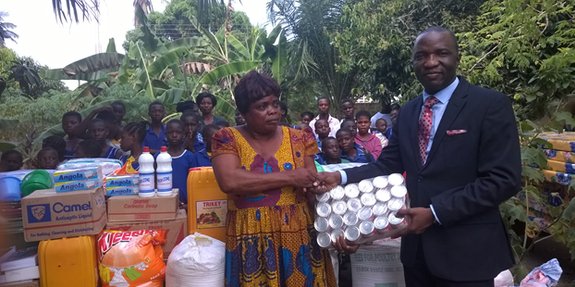 Founder of the orphanage Emma Boafo is receiving goods from a company operating in the community