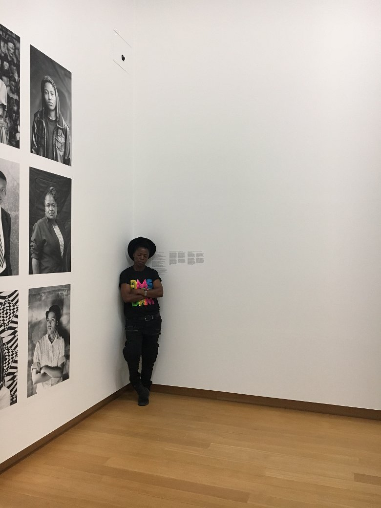 Zanele Muholi in front of her Faces & Phases portraits in Stedelijk Museum. Photo: Nicole Segers