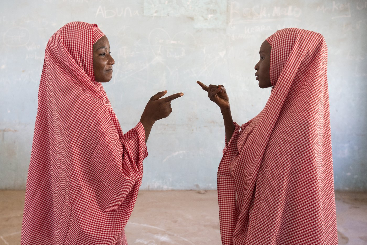 Amina and Zainab playing a clapping game, Tatsuniya, from the series Education is Forbidden, 2017 ©Rahima Gambo, courtesy Red Hook Labs