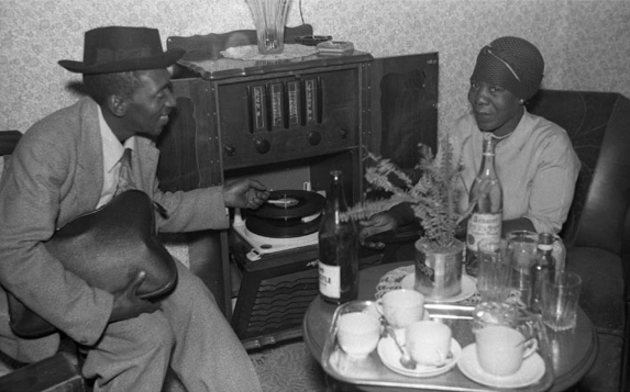 Photo: from the book Common Place. A Wattville lounge with its plethora of objects evoking Western urban lifestyle. Early 1960s, by Torrance Ngilima