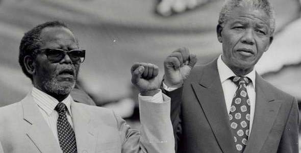 Oliver Tambo and Nelson Mandela give black power salutes on Sunday, December 16, 1990 in Johannesburg. Photographer unknown. 