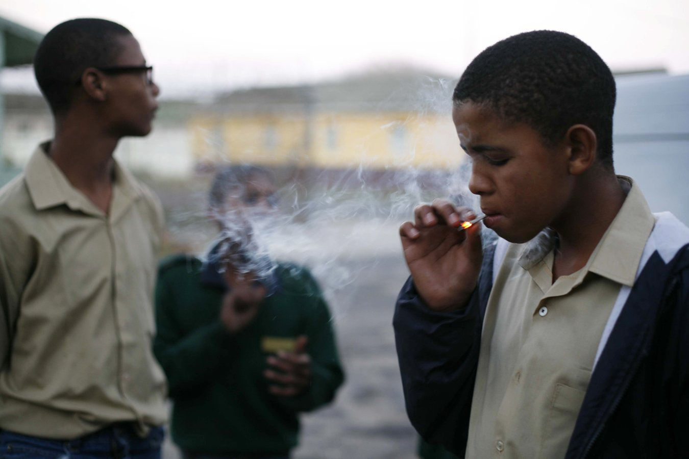 Photo: Ottery Reformatory. Boys too young to serve sentences in adult facilities are sent here. Smoke break after rehearsing for a rendition of Shakespeare’s Julius Caesar, an incredible experience for many of the boys. Cape Town, 2013 ©Yasser Booley. Courtesy of Yasser Booley and Joan Legalamitlwa