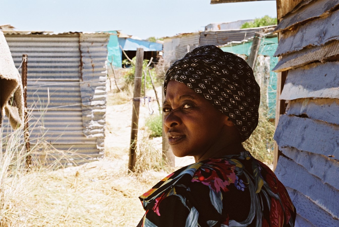 A woman photographed close to her home for a story on families living on less than a dollar a day for the Mail & Guardian, Khayelitsha Site C, Cape Town, 2004